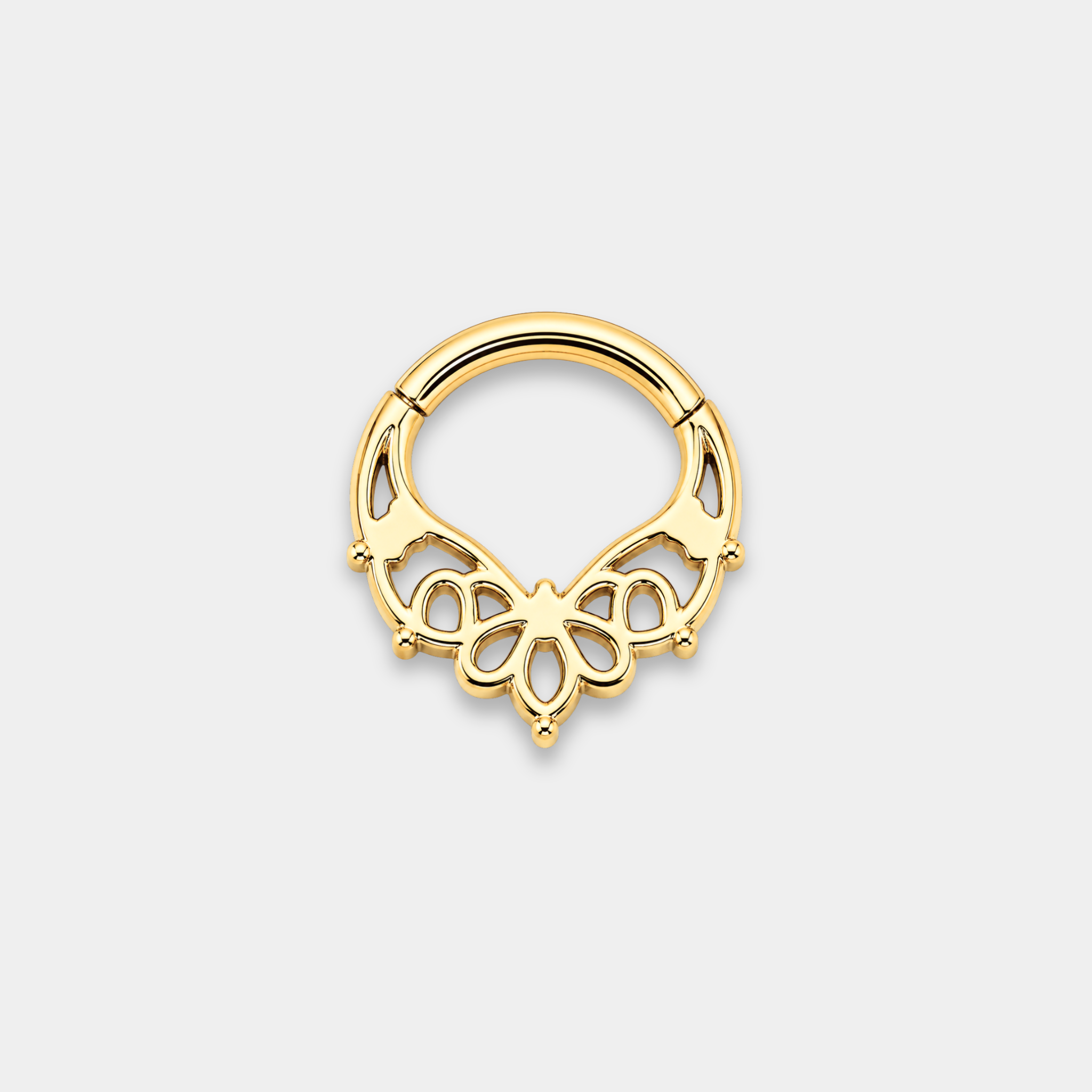 Anneau piercing Aura en titane gold vu de dos avec motifs ajourés floraux et trois zircons sertis