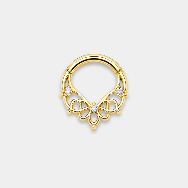 Anneau piercing Aura en titane gold avec motifs ajourés floraux et trois zircons sertis de face