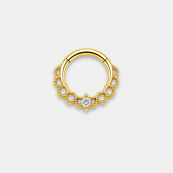 Anneau piercing Aurea en titane gold avec détails perlés ajourés et zircon central serti de face