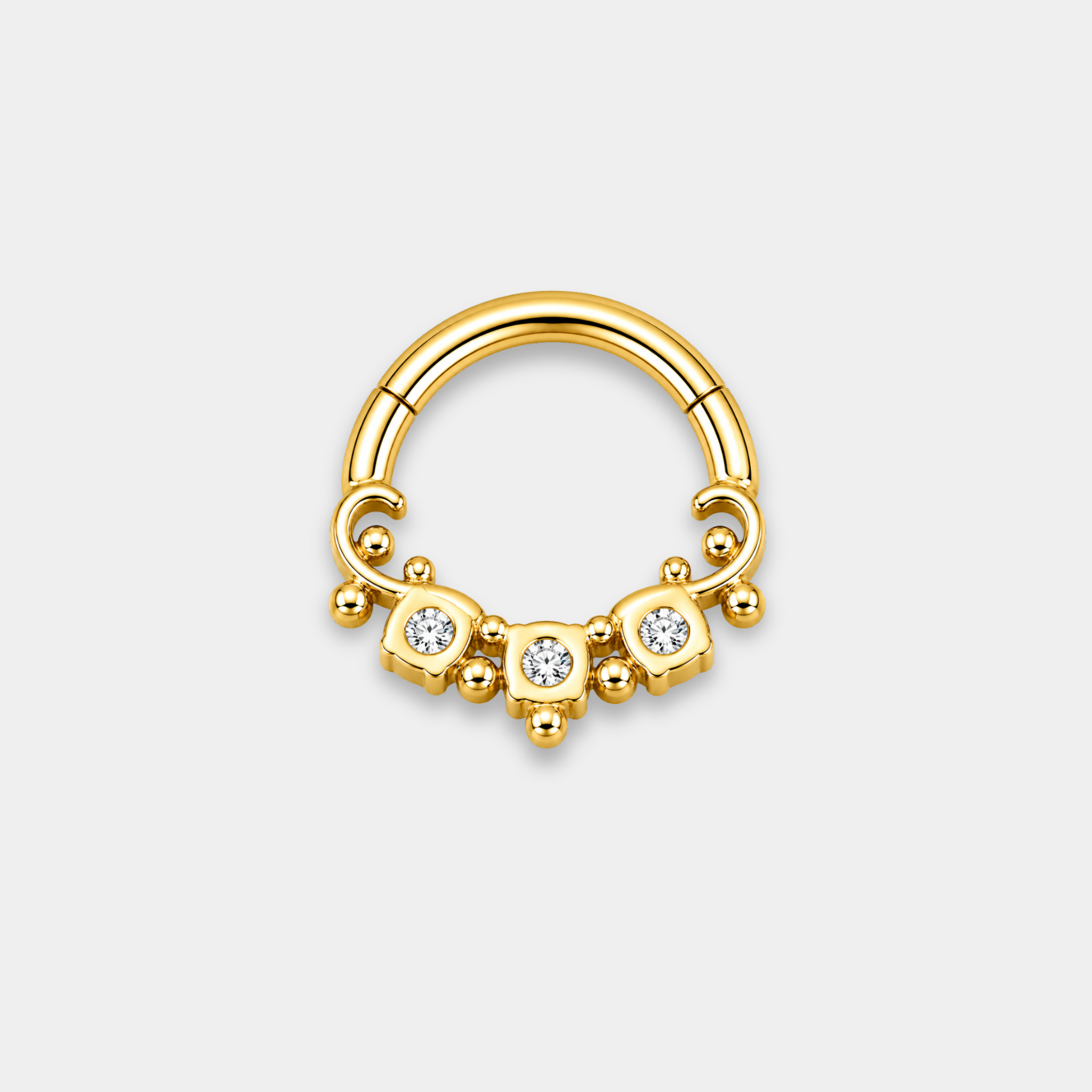 Anneau piercing Aurel en titane gold vu de dos avec trois zircons sertis et détails perlés