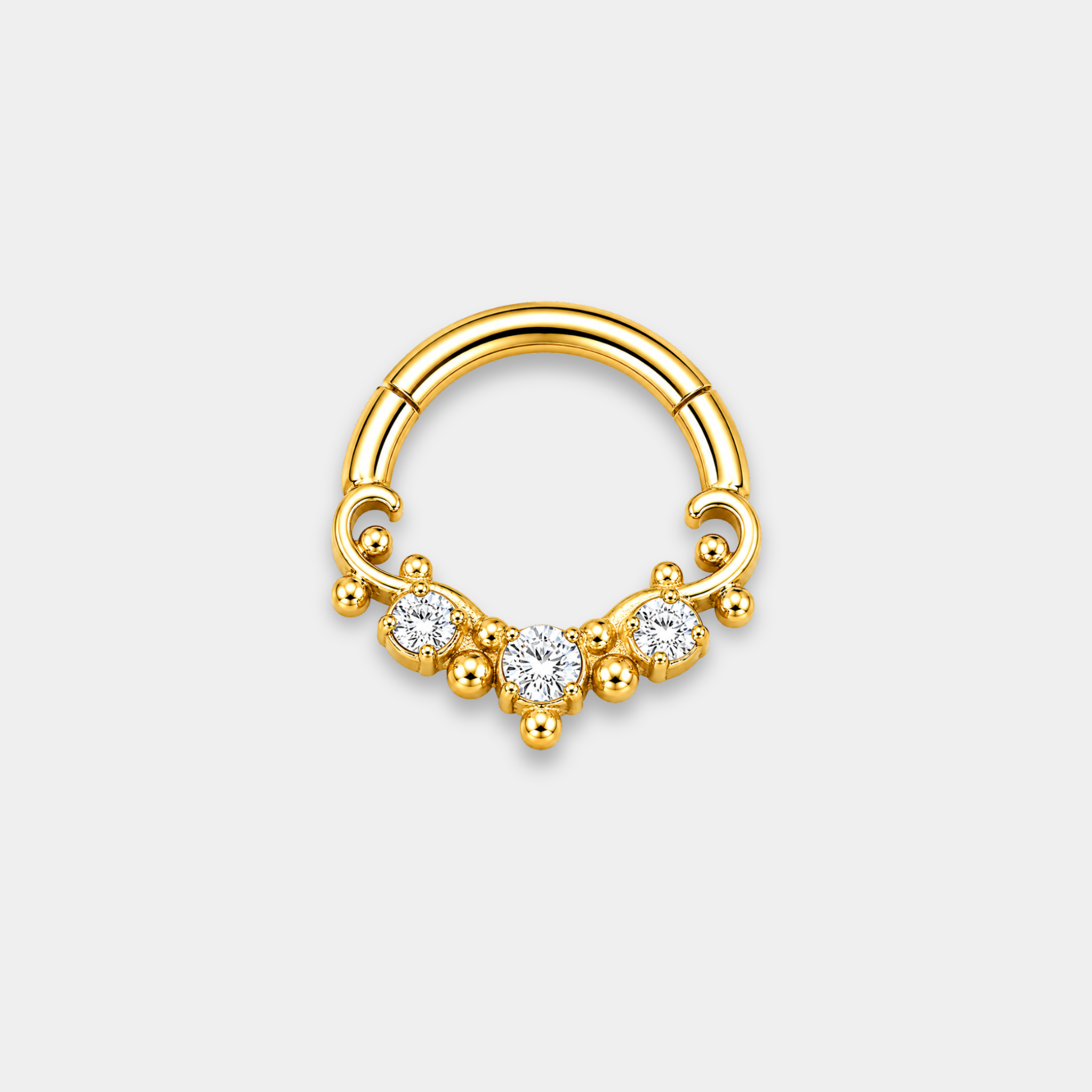 Anneau piercing Aurel en titane gold avec trois zircons sertis et détails perlés de face