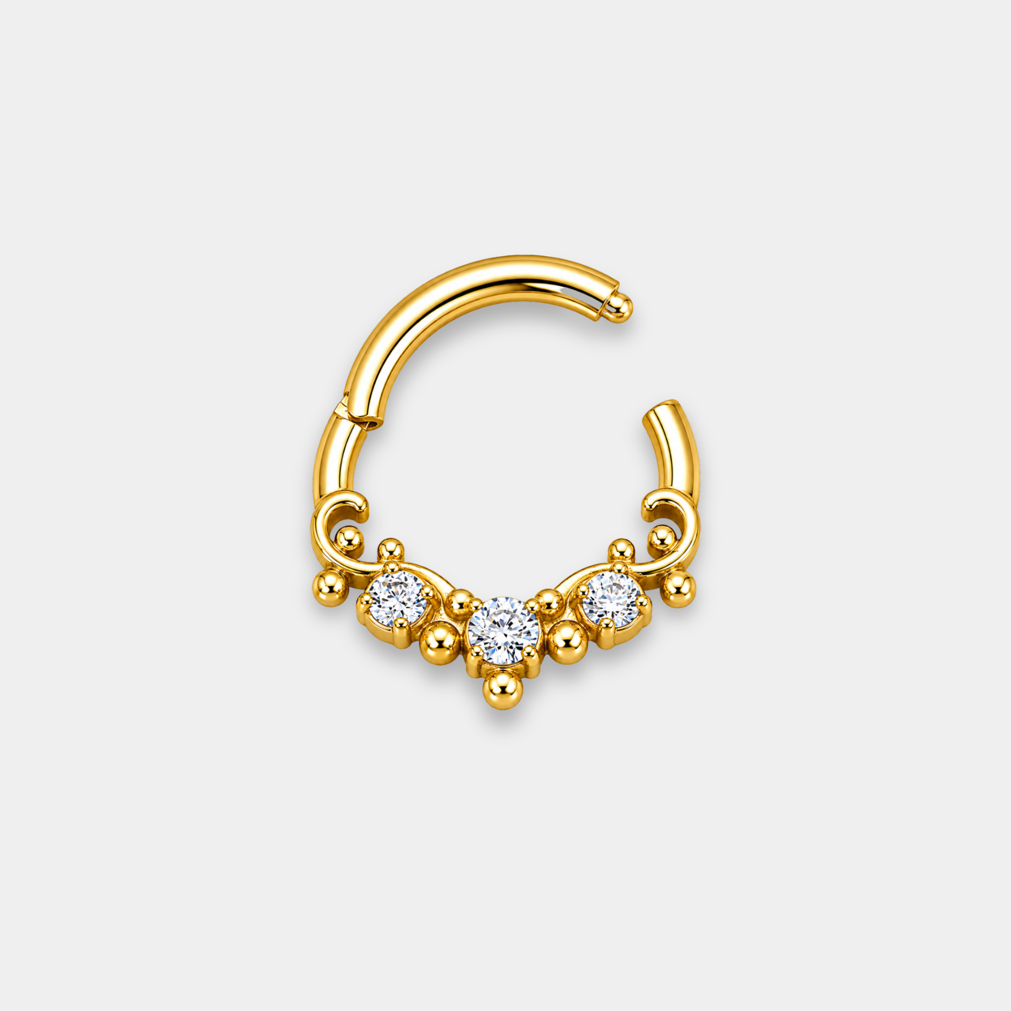 Anneau piercing Aurel ouvert en titane gold avec trois zircons sertis et détails perlés