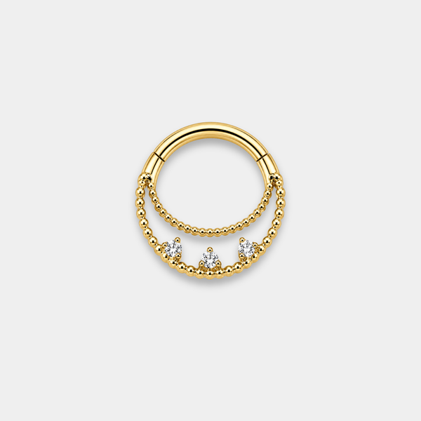Anneau piercing Elio en titane gold avec double rangée perlée et trois zircons sertis de face