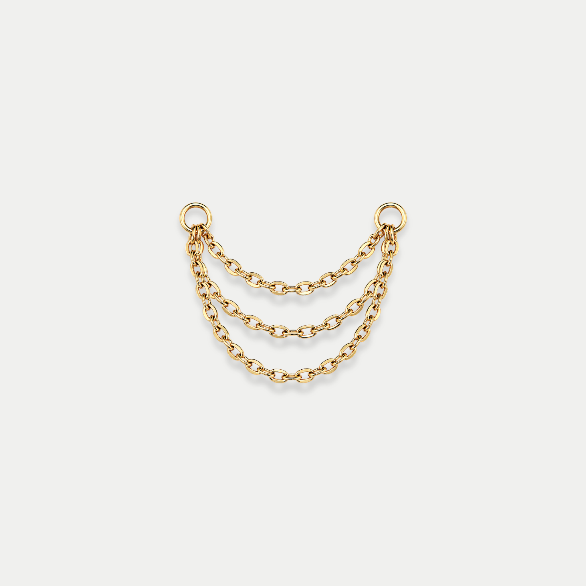Chaîne triple de piercing en titane gold avec trois rangées reliées entre deux anneaux