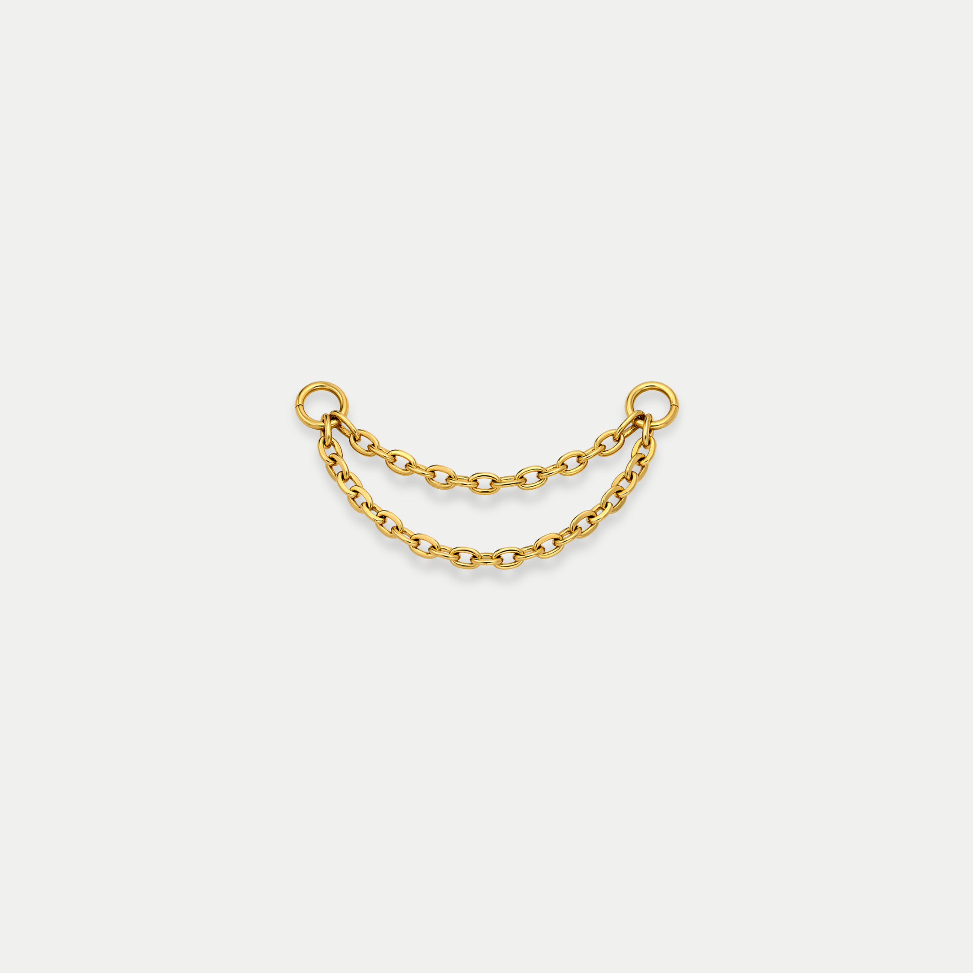 Chaîne double de piercing en titane gold avec deux rangées reliées entre deux anneaux