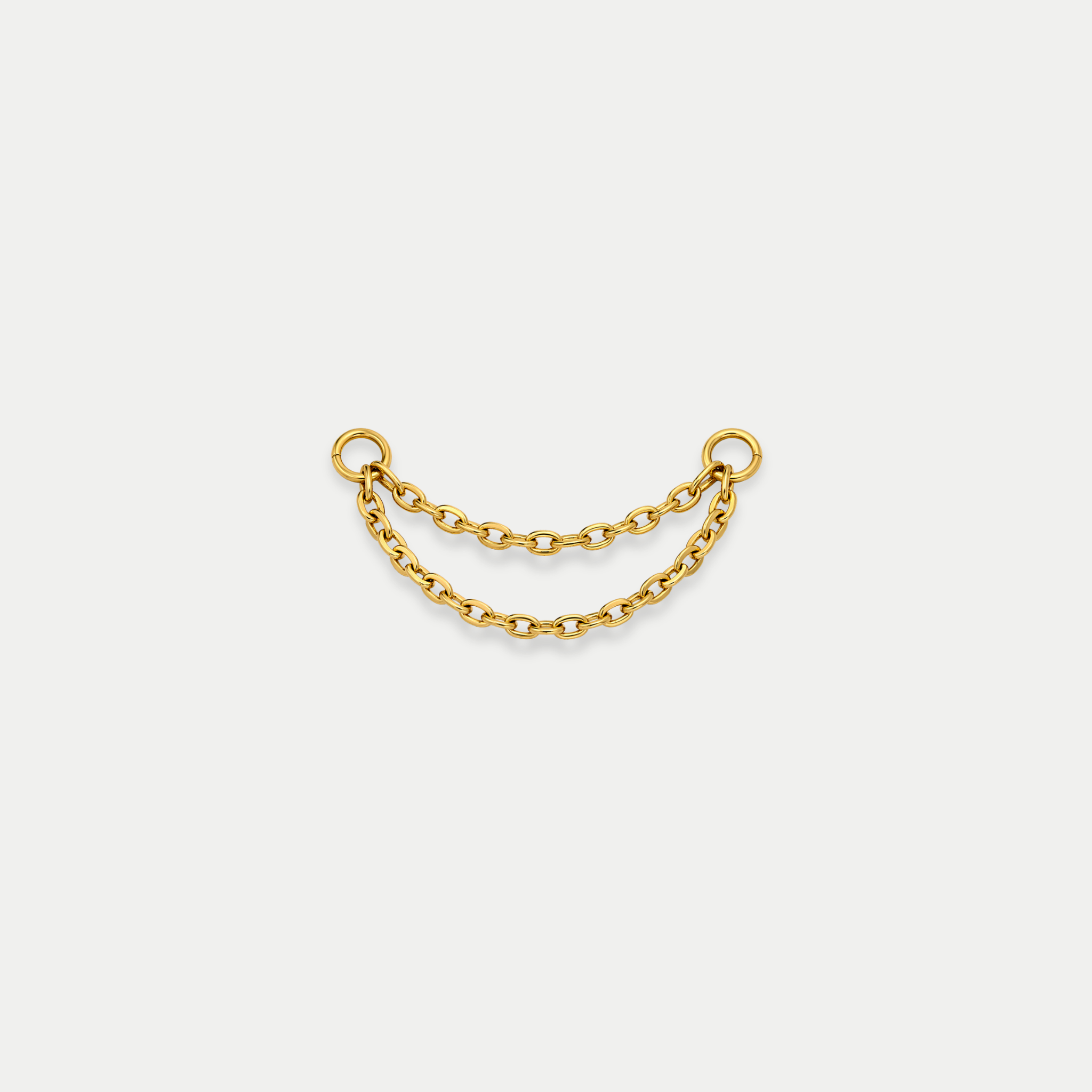 Chaîne double de piercing en titane gold avec deux rangées reliées entre deux anneaux